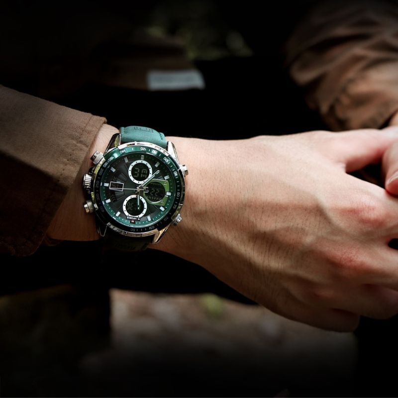 Aether Voyage Men's Quartz Watch with a green leather band and green dial, worn on a man's wrist, with a dark, blurred background.