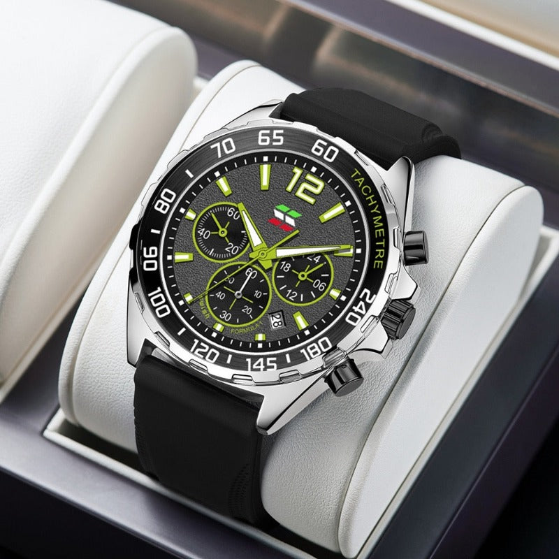 Apex Dusk men's quartz watch with luminous hands and date display, featuring a black dial, green accents, and a black silicone strap, presented on a white display stand.