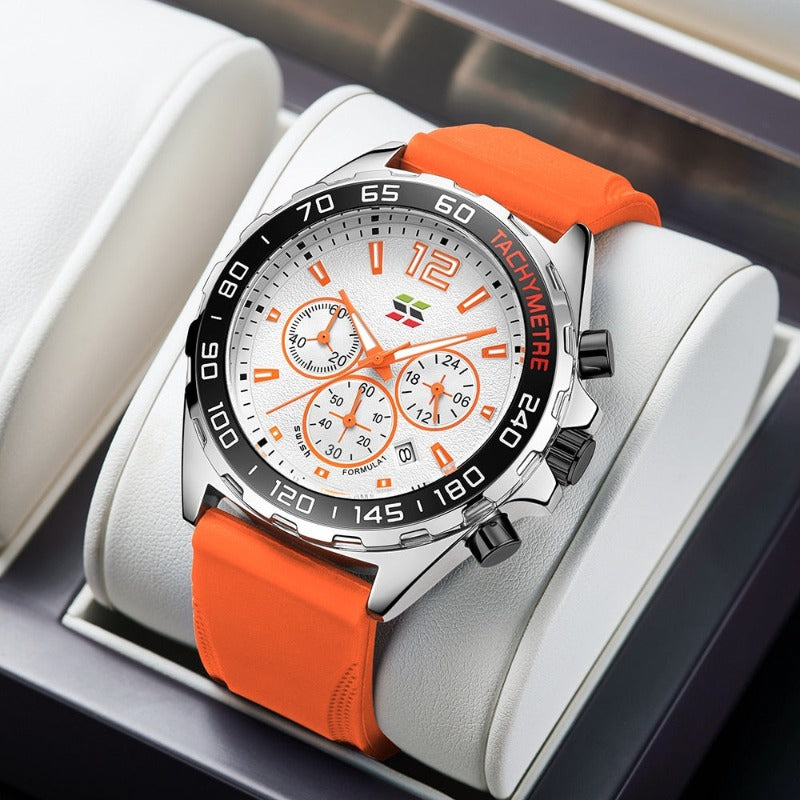 Apex Dusk men's quartz watch in silver orange variant, featuring a silver case, white dial with orange luminous hands and markers, chronograph subdials, and an orange silicone strap, displayed on a white watch stand.