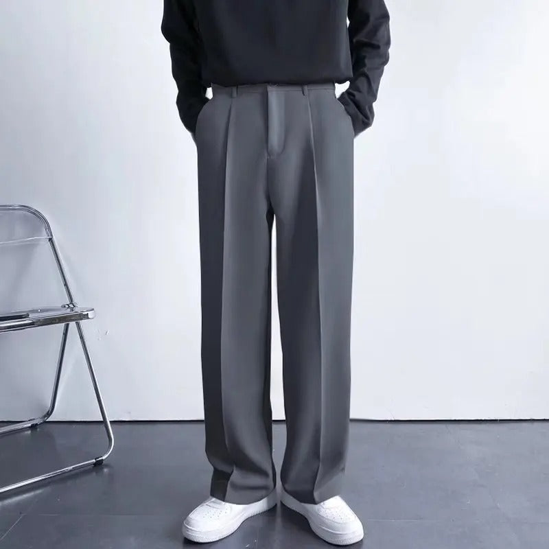 Men's Arno Trousers in gray linen, tailored fit, shown on a model wearing a black long-sleeve shirt.