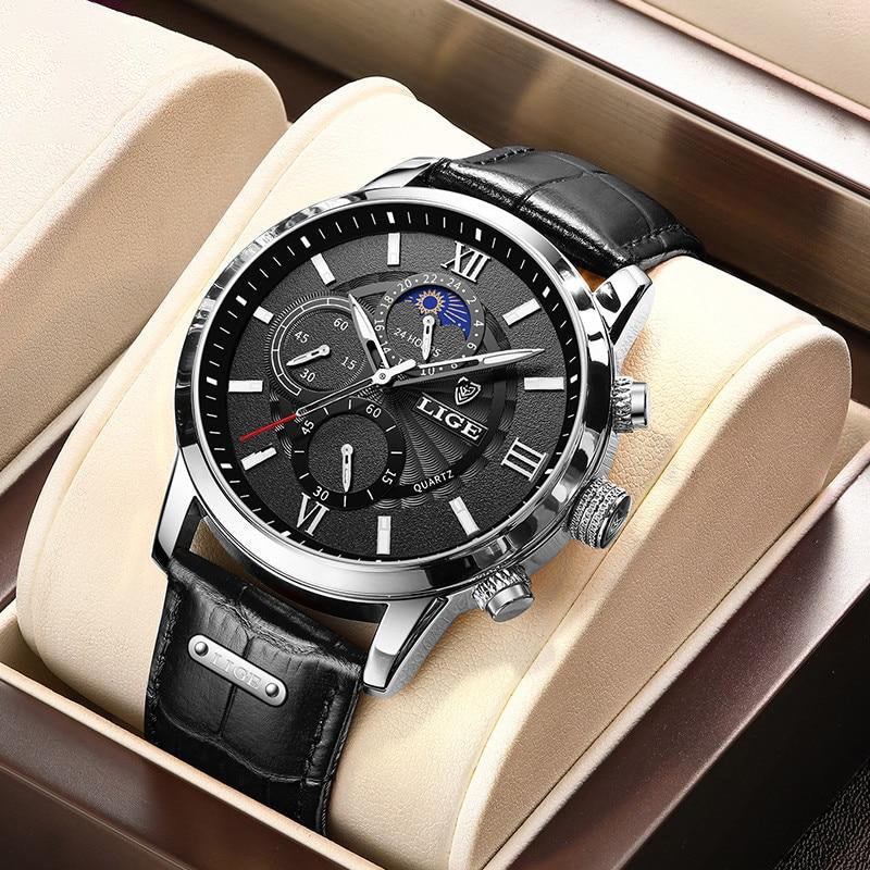 Aurelius Timepiece men's watch with silver case, black dial, and black crocodile-patterned leather strap, featuring luminous hands and a moon phase complication, displayed in a beige watch box.