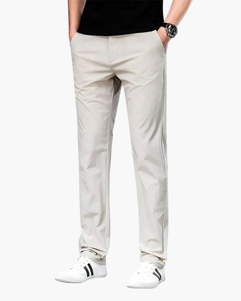 Men's Cielo Vento white casual trousers in lightweight cotton, shown on a model with hands in pockets, highlighting the relaxed fit. Paired with a black t-shirt and white sneakers.
