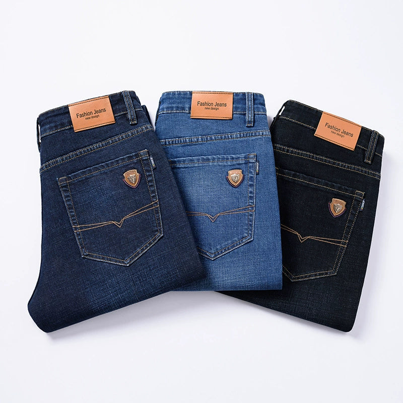 Three folded Cityscape Trousers men's premium cotton classic fit pants in dark blue, light blue, and black, displayed from the rear view showing back pockets and brand labels.