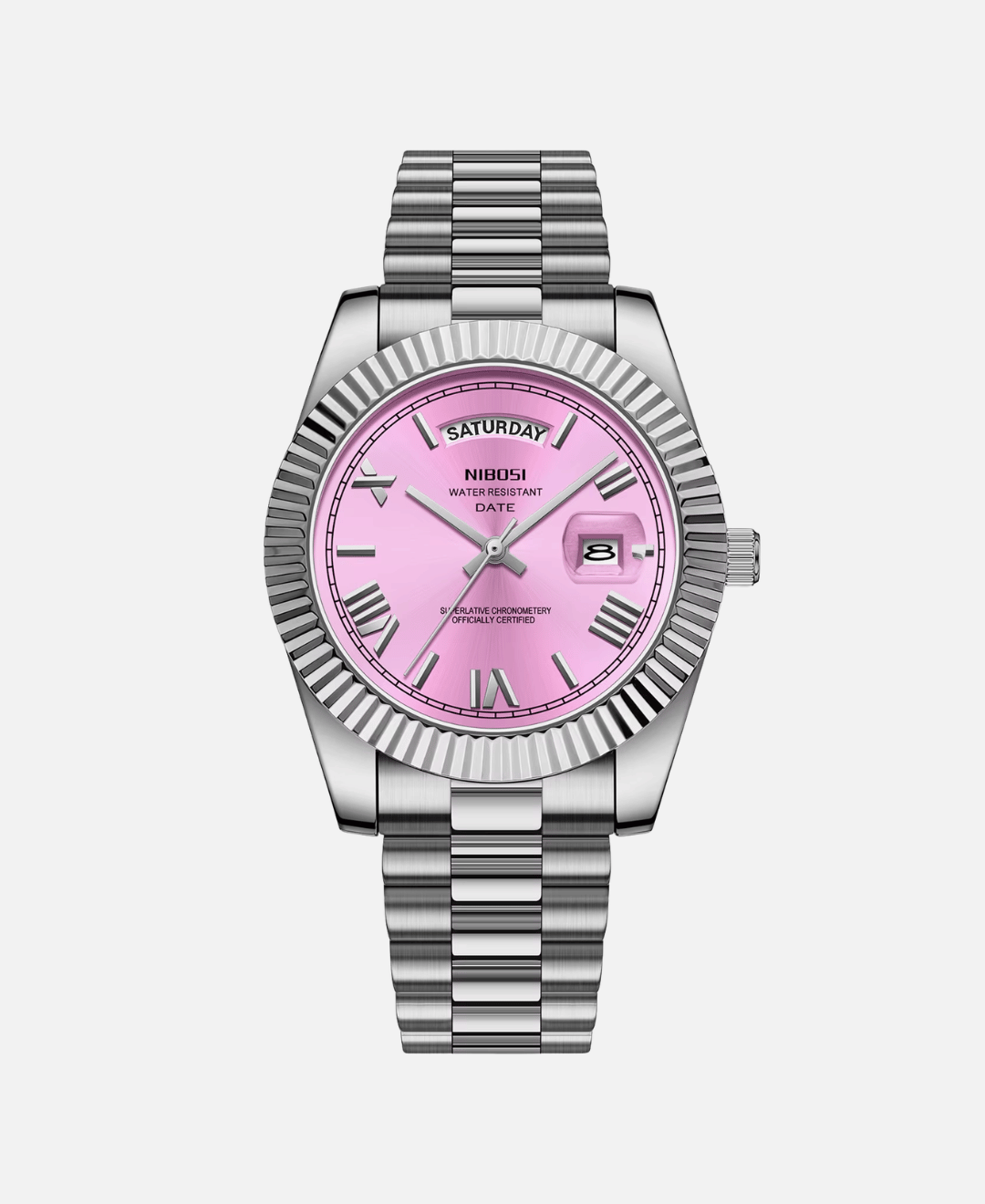 Dateday Classic Watch with a silver-tone stainless steel case, fluted bezel, and metal bracelet. The watch features a soft pink dial with Roman numeral hour markers, a day display showing 'SATURDAY', and a date window showing '8'.