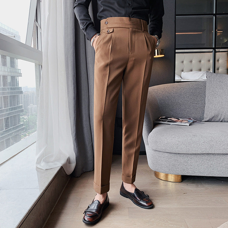 Elysian Trousers brown high-waisted slim-fit men's trousers. Premium fabric tailored finish. Man modeling smart casual office pants with a black shirt, standing indoors.
