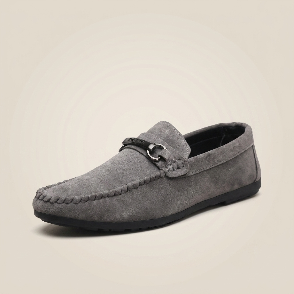 Three-quarter angle of gray bucket loafer showing open toe, metal buckle closure, and lightweight design