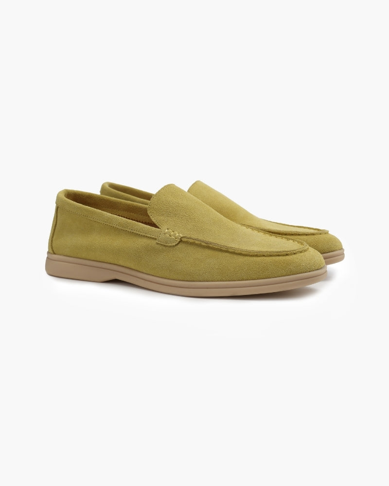 Heritage Luxe men's light green suede loafers with classic stitching, shown as a pair from an angle on a white background. Stylish and comfortable footwear.