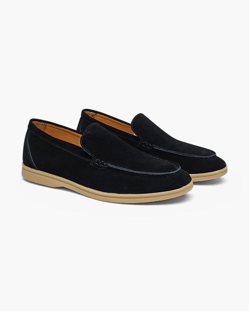 Men's Heritage Luxe black suede loafers with classic stitching and a light tan sole, presented on a clean white background.