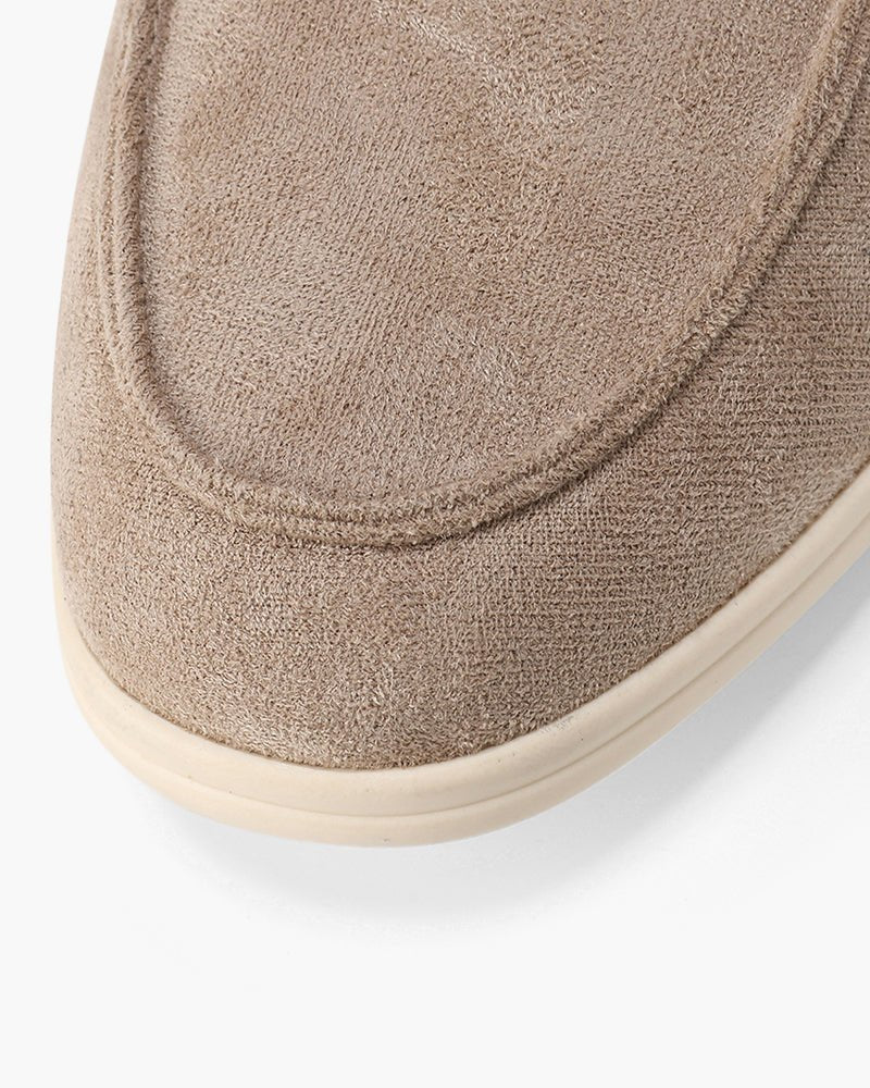 A close-up view of the toe box of a Heritage Luxe beige suede loafer, highlighting the classic stitching detail and soft suede texture.