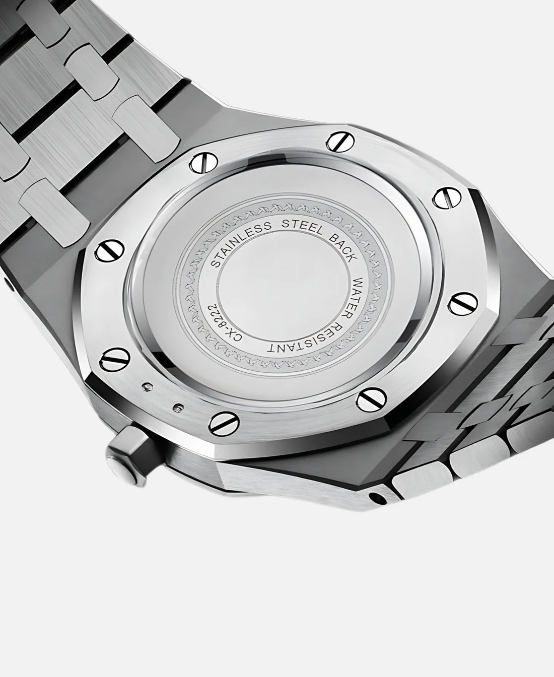 Close-up back view of a silver watch case, highlighting engraved details like 'STAINLESS STEEL BACK' and 'WATER RESISTANT'.