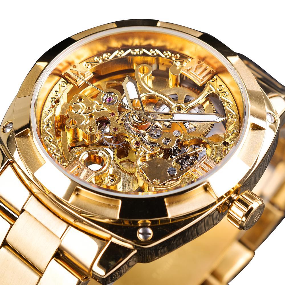 A close-up view of the Luxe Aura Men's Analog Watch in gold stainless steel, showcasing its intricate skeleton dial and luminous hands. The mechanical gears are visible through the transparent face.