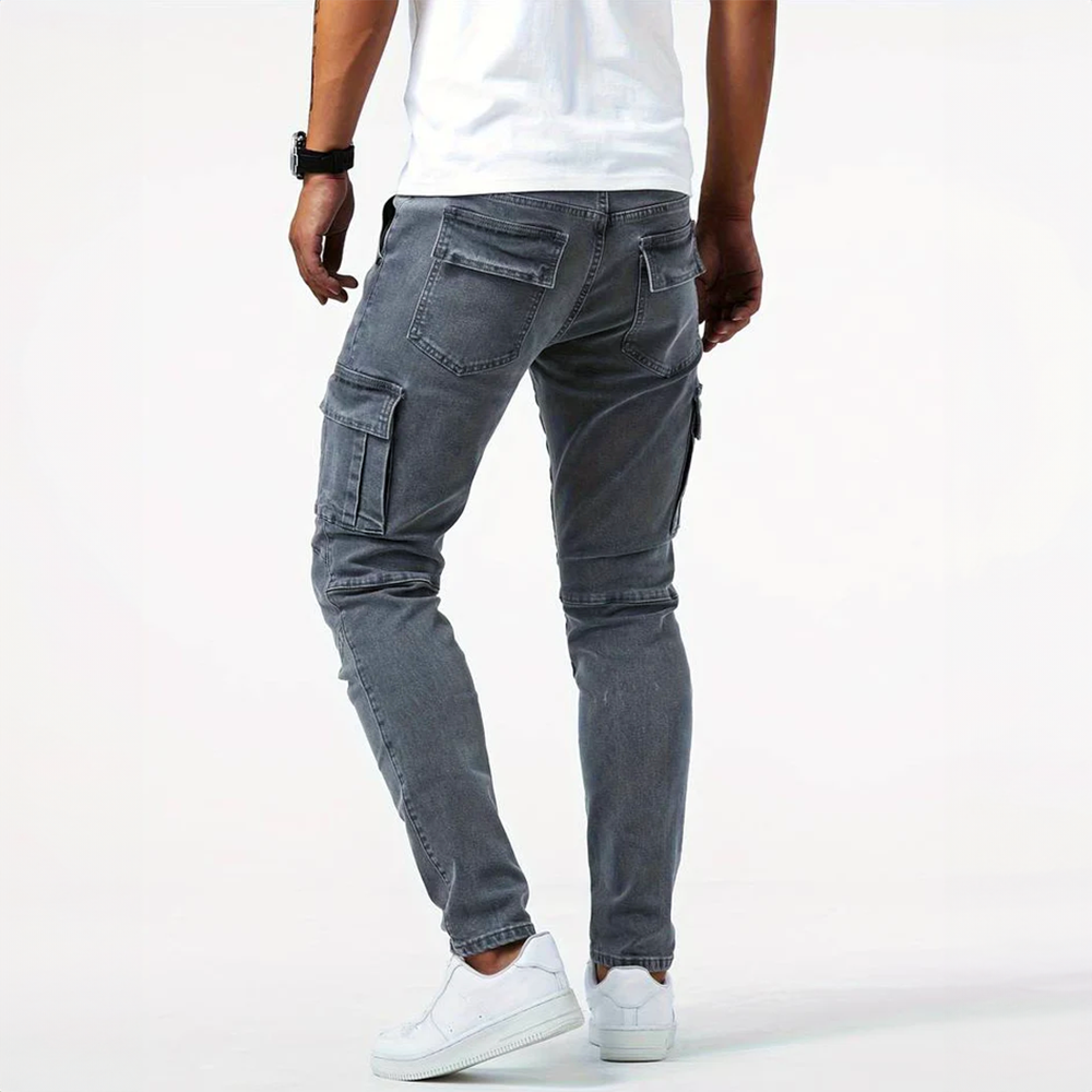 Back view of men's Metro Blue Cargo Trousers in gray, showcasing the rear pockets and the fit on a model. The cargo pants have a comfortable, versatile design suitable for everyday wear.