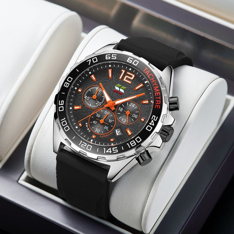 Apex Dusk men's quartz watch with luminous hands and date display, featuring a black dial, orange accents, and a black silicone strap, presented on a white display stand.