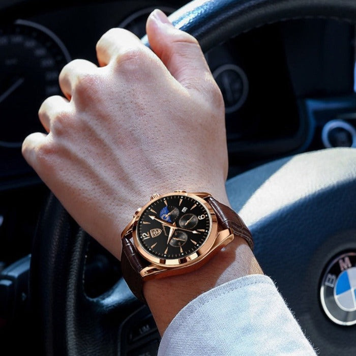 Aventadori men's watch in rose gold with a dark brown leather strap worn on a man's wrist, holding a car steering wheel. Showcases the watch in a lifestyle context, highlighting its casual luxury and elegant design.