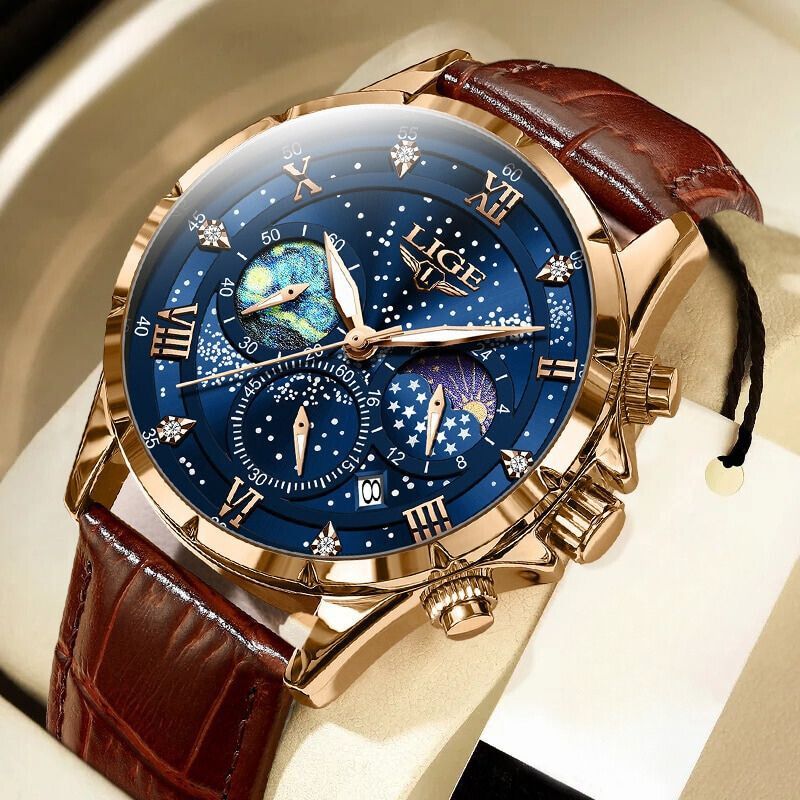 Men's Celestial Timekeeper watch in rose gold with a blue starry chronograph dial, moon phase display, and brown leather strap, presented on a white watch cushion.
