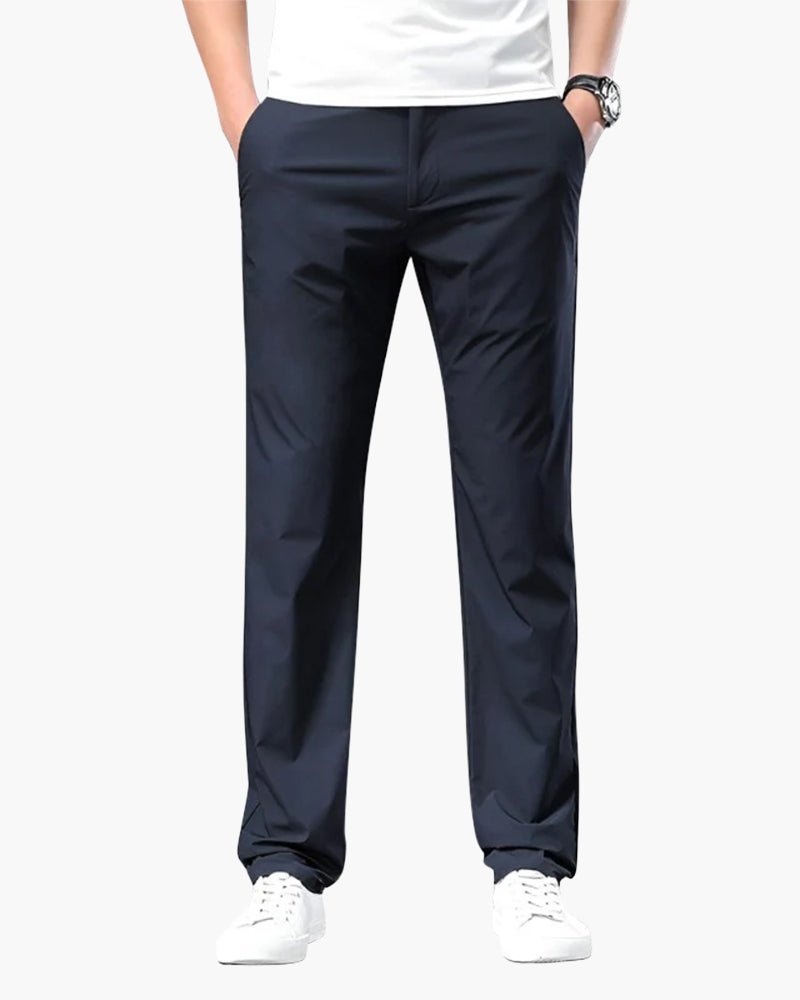Men's Cielo Vento blue casual trousers in lightweight cotton, shown on a model with hands in pockets, highlighting the relaxed fit. Paired with a white t-shirt and white sneakers.
