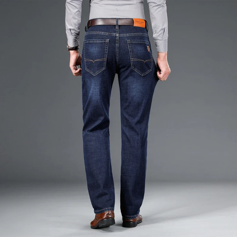 Back view of a man wearing Cityscape Trousers in dark blue, showing the classic fit and pocket details.
