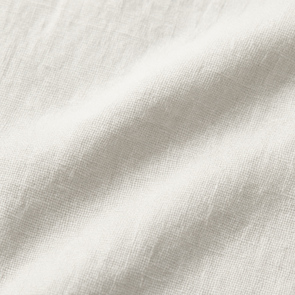 Close-up view of white linen fabric, highlighting its natural texture and breathable weave, ideal for Elysian Breeze Trousers.