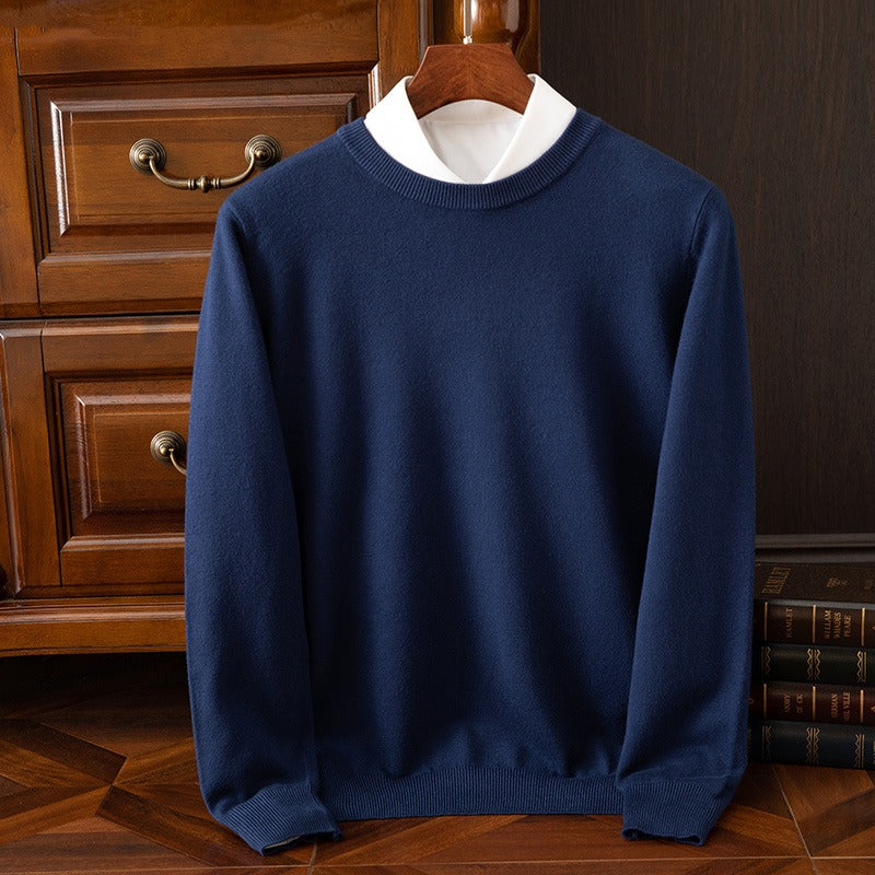 Navy blue cashmere sweater with a white collar on a wooden hanger, displaying its deep hue and luxurious softness. A timeless and comfortable knitwear piece.