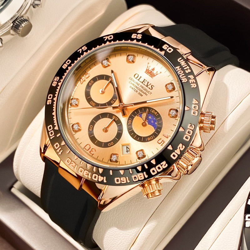 Men's Elysium Timepiece watch with a champagne dial, rose gold-tone case, black silicone strap, quartz movement, luminous hands, and date display, displayed on a white stand. Features three subdials and diamond-like hour markers.