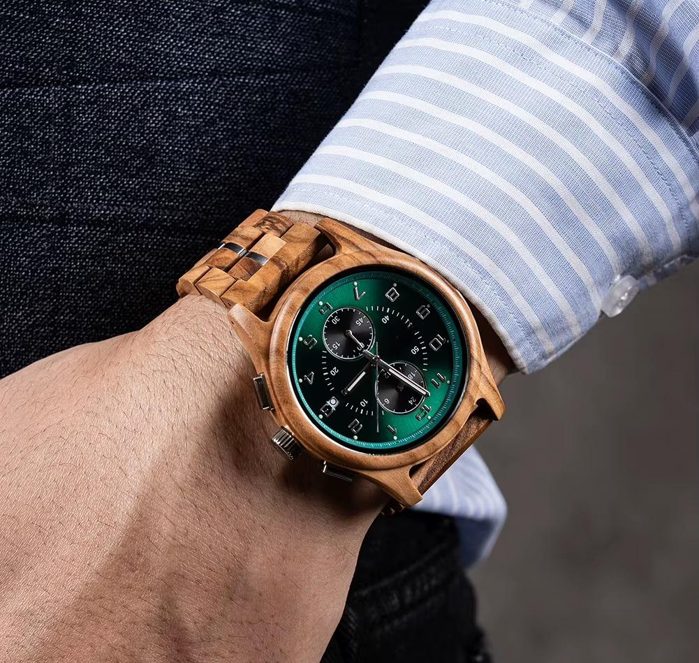 Close-up of a man's wrist wearing the Emerald Grove wooden watch with a vibrant green dial and eco-friendly finish, paired with a striped blue shirt.