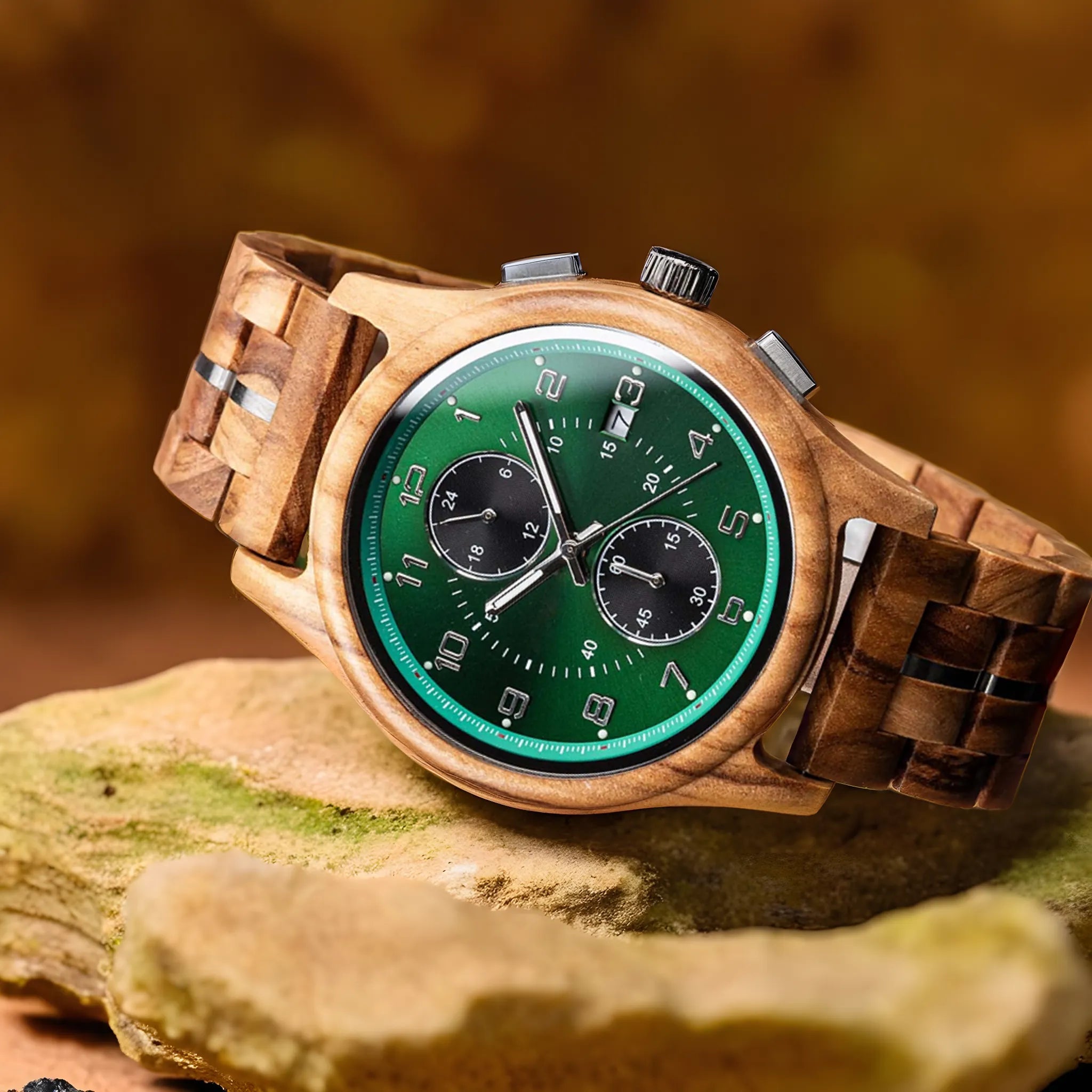 The Emerald Grove men's wooden watch with a green dial and wooden strap, resting on a piece of natural wood or rock, highlighting its eco-friendly design.