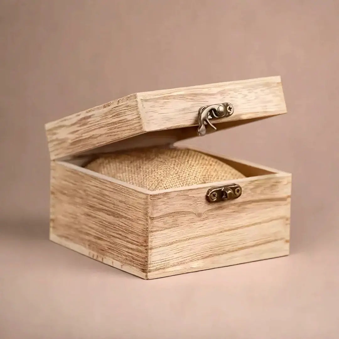 Open light-colored wooden watch box with metal clasps and a burlap cushion inside, ready for a Heritage Oak men's watch.