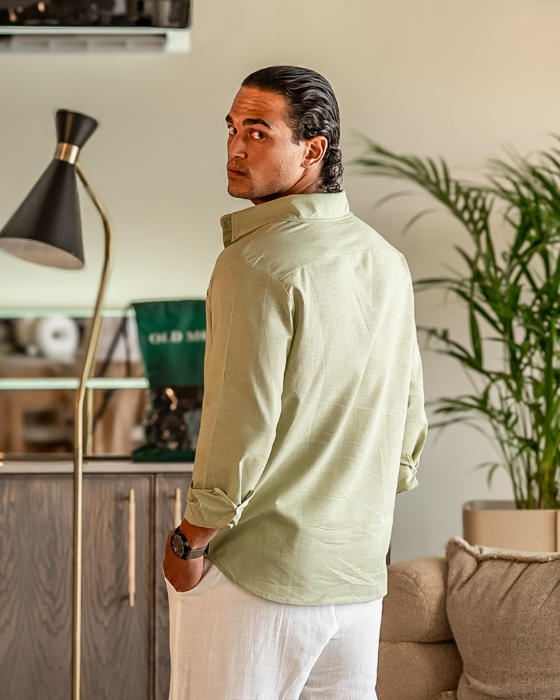 Male model wearing a Mint Green Linen Essence men's shirt with a classic fit, sleeves rolled up, shown from the back. Highlights the comfortable fit and breathable linen fabric.