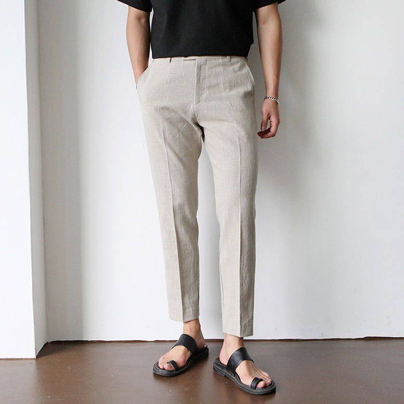 Luxe Harbor beige linen trousers with a tailored fit, shown on a male model from the front. These soft fabric pants are a versatile addition to any summer wardrobe.