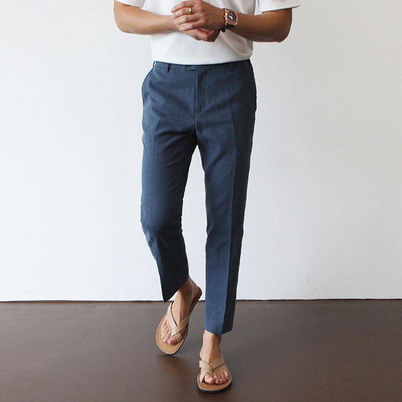 Luxe Harbor navy blue linen trousers with a tailored fit, shown on a male model from the front. These stylish, lightweight pants offer versatile casual wear.