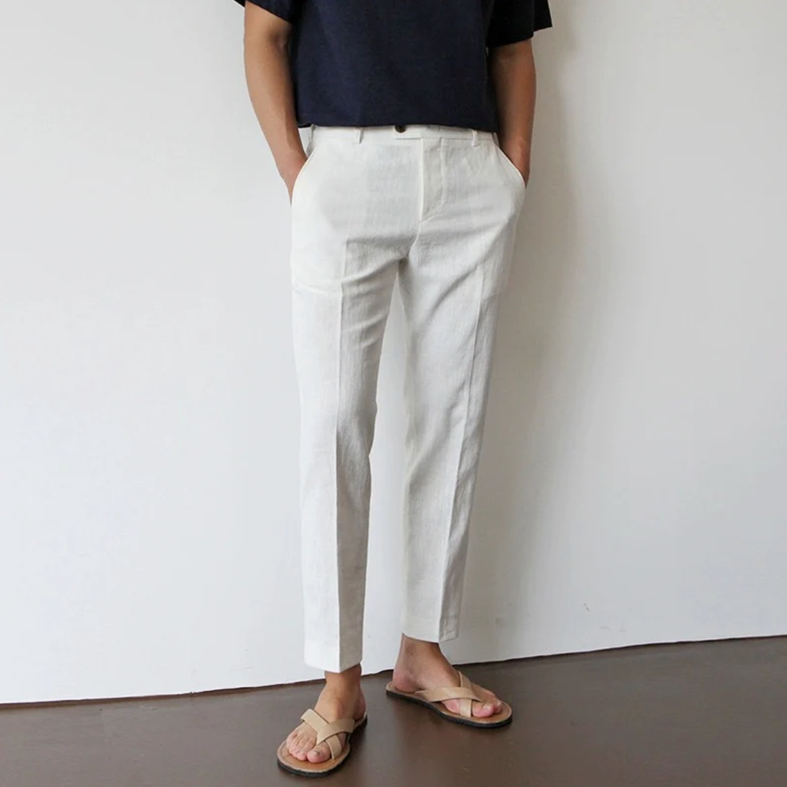 Luxe Harbor white linen trousers with a tailored fit, shown on a male model from the front. These soft, breathable pants are perfect for summer fashion and casual wear.