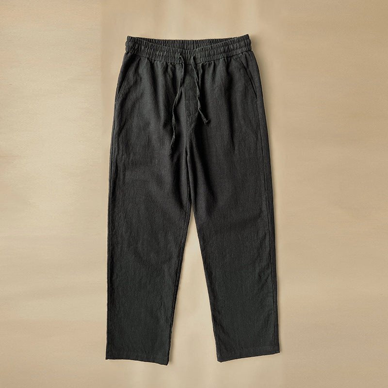 Luxe Retreat Comfy Linen Pants with Relaxed Fit in black, laid flat, highlighting the comfortable elastic waist and drawstring. Versatile bottoms for any casual occasion.