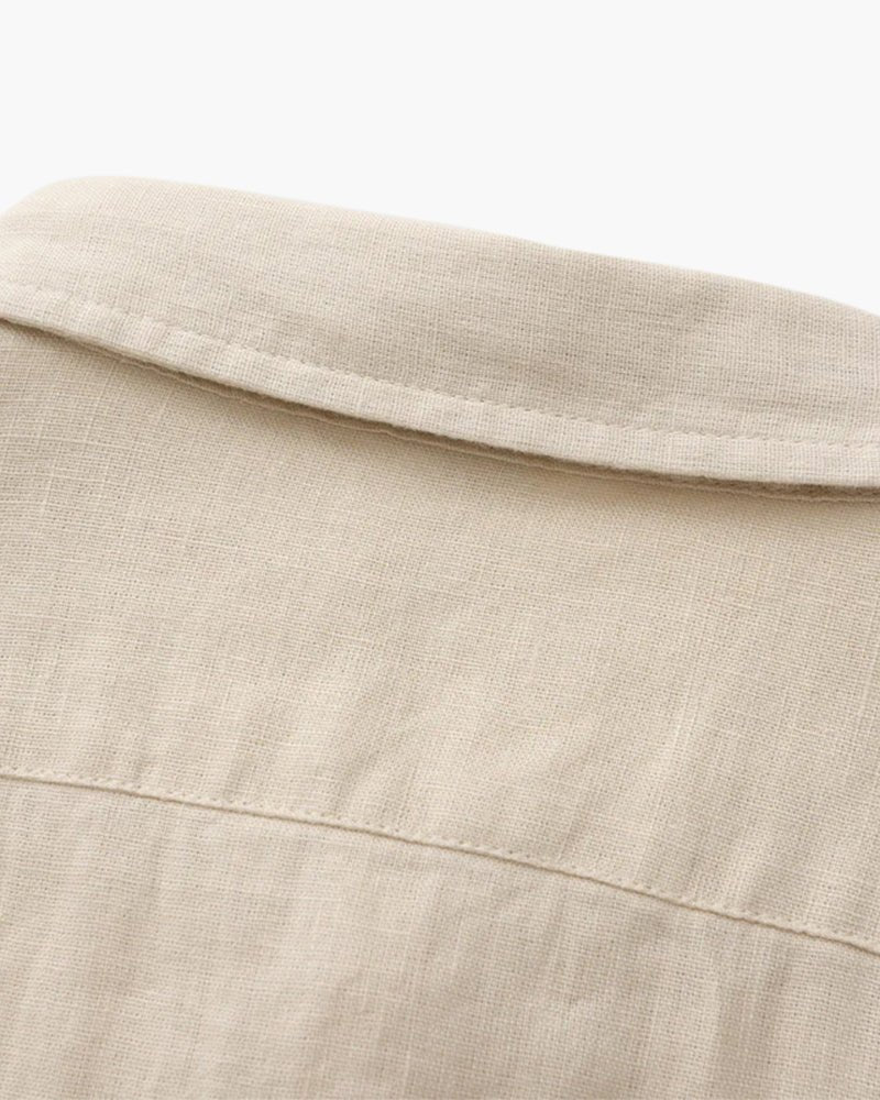 Close-up view of the collar and upper back of a beige Linen Essence men's shirt, highlighting the natural linen fabric texture and detailed stitching.