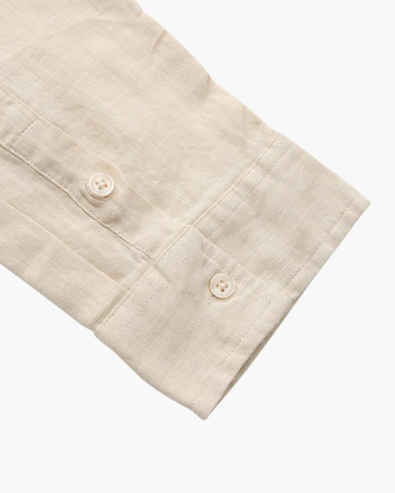 Detailed close-up of the cuff and sleeve of a beige Linen Essence men's shirt, showcasing the buttons and the breathable linen fabric texture.