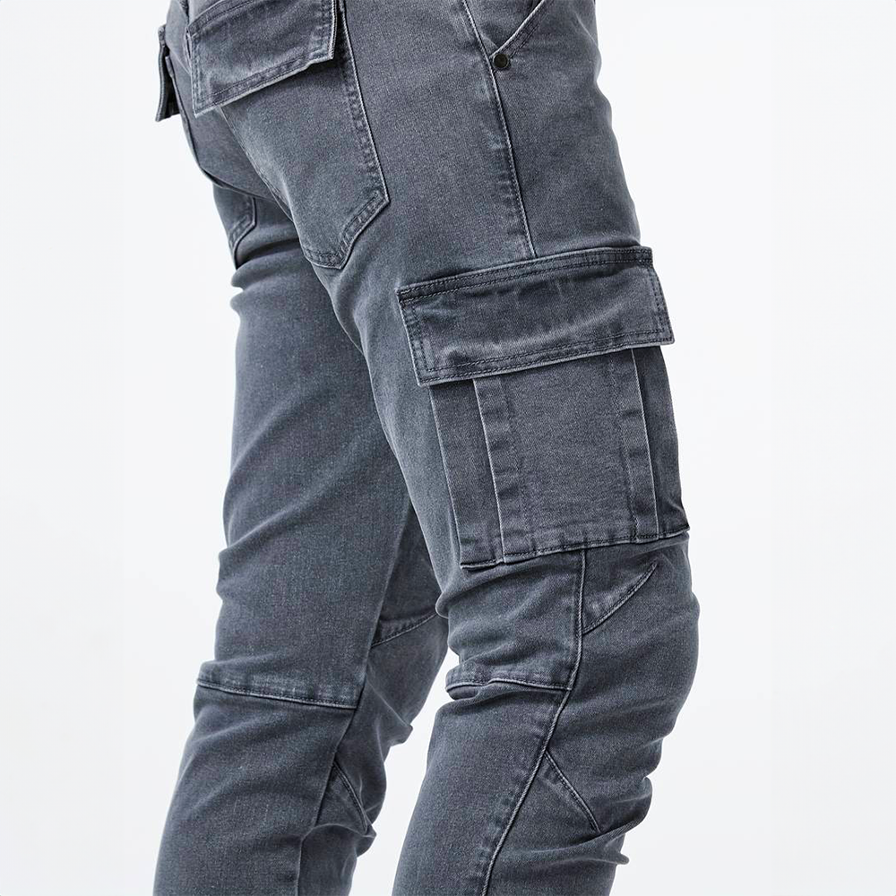 Metro Blue Cargo Trousers. Close-up view of gray cargo trousers on a model, highlighting the side cargo pocket and denim texture.