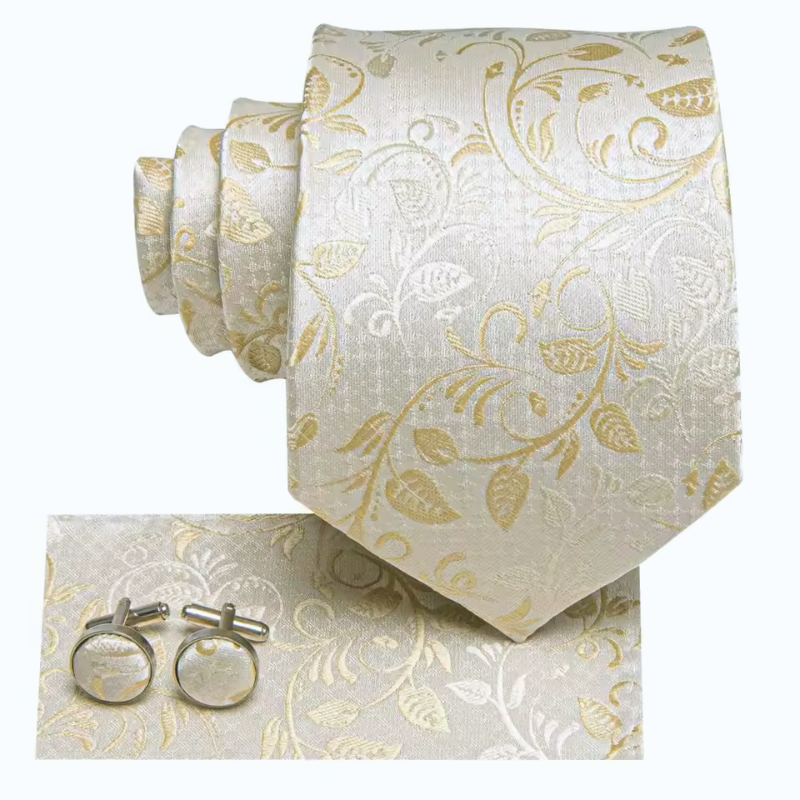 Set of beige tie, pocket square, and cufflinks with gold floral pattern on a white background