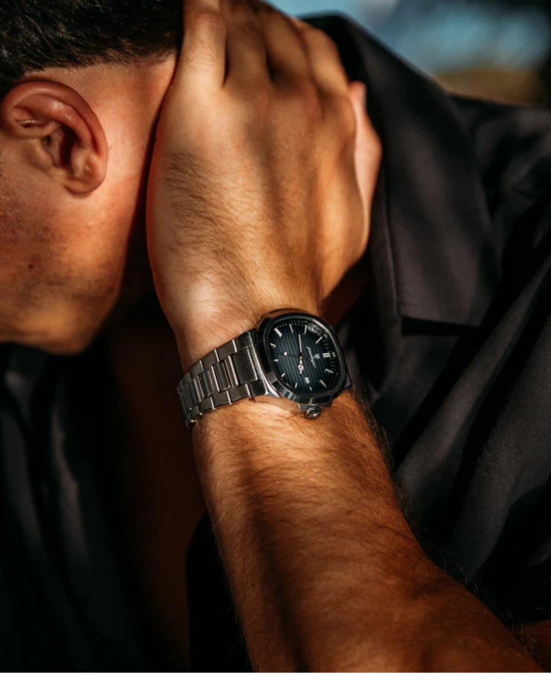 Nautilus Luxury Watch Stainless Steel Sapphire Crystal on a man's wrist, showcasing the elegant design and durable metal strap.