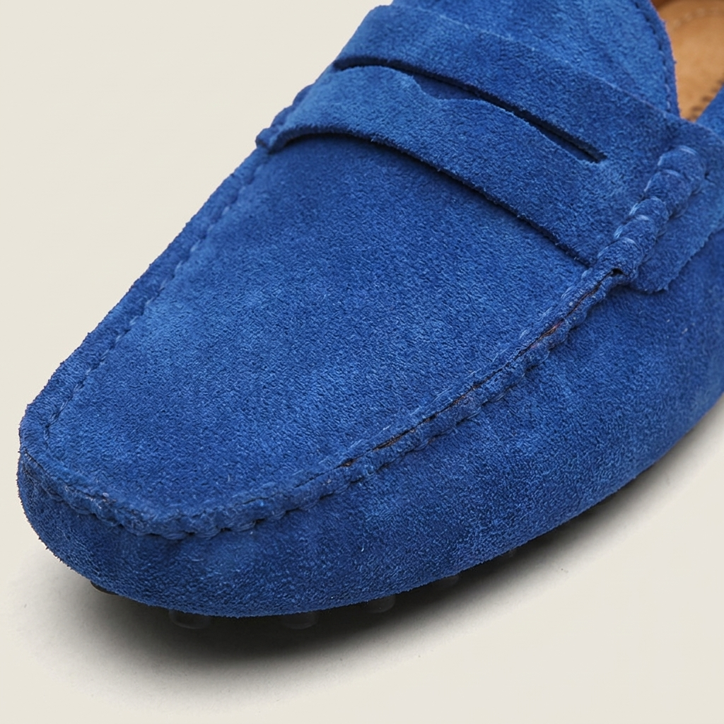 Gray nubuck leather breathable slip-on loafer front detail close-up showing round toe, flat heel and stitching craftsmanship