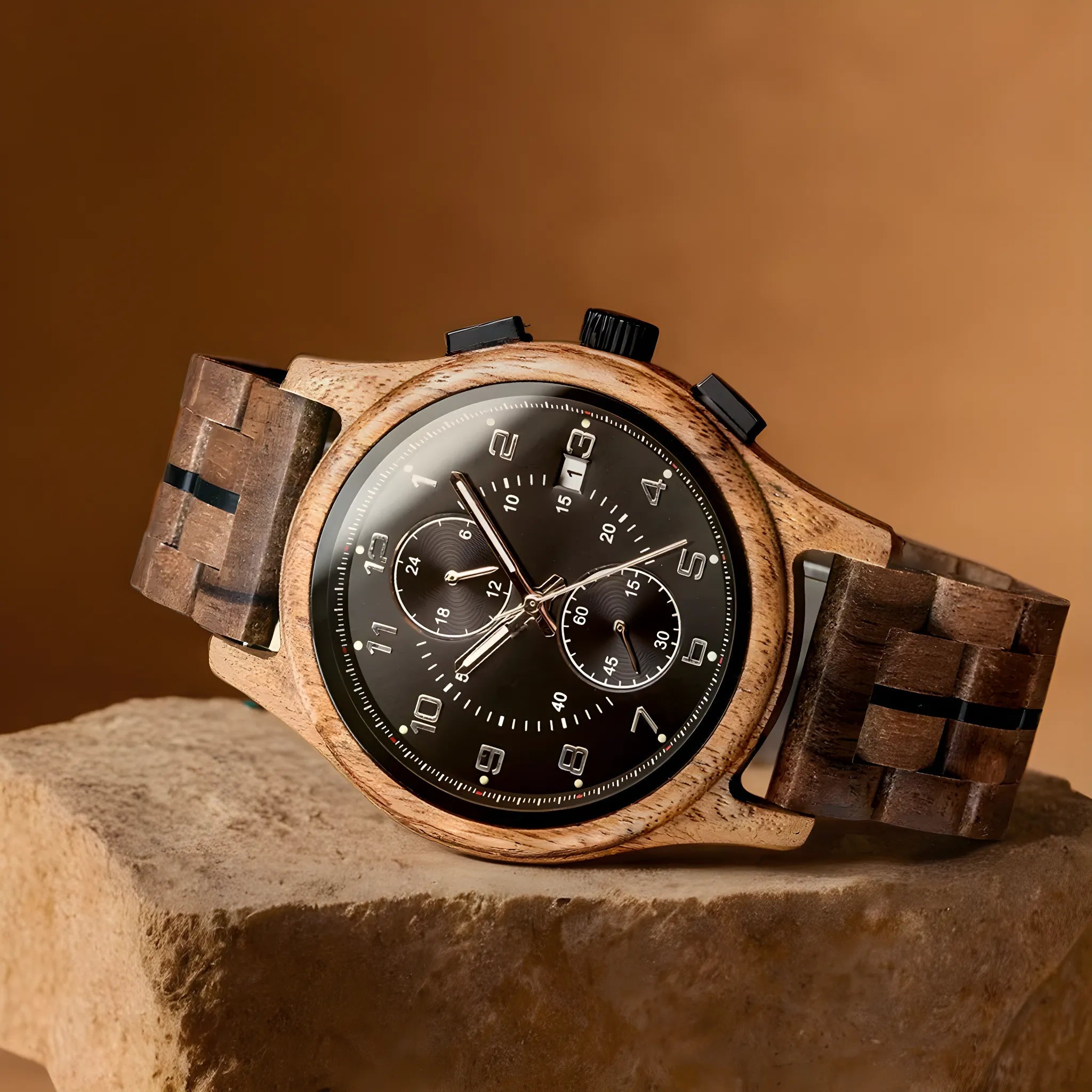 Front angled view of the Regal Oak men's watch with walnut finish and silver accents, featuring a dark dial with chronograph subdials, resting on a light brown rock.