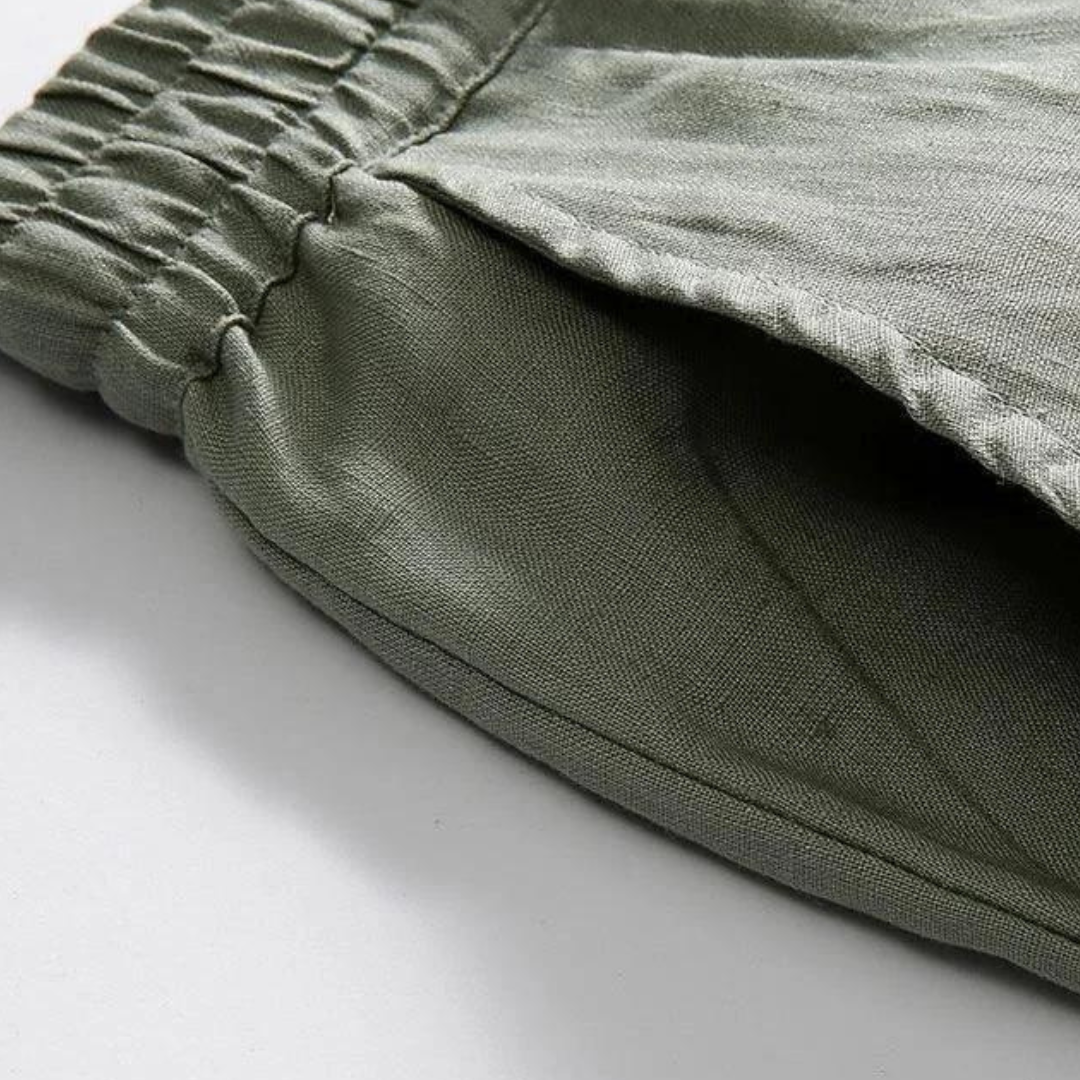 Close-up of Sahara Whisper green linen pants, highlighting the practical side pocket and comfortable elastic waistband.