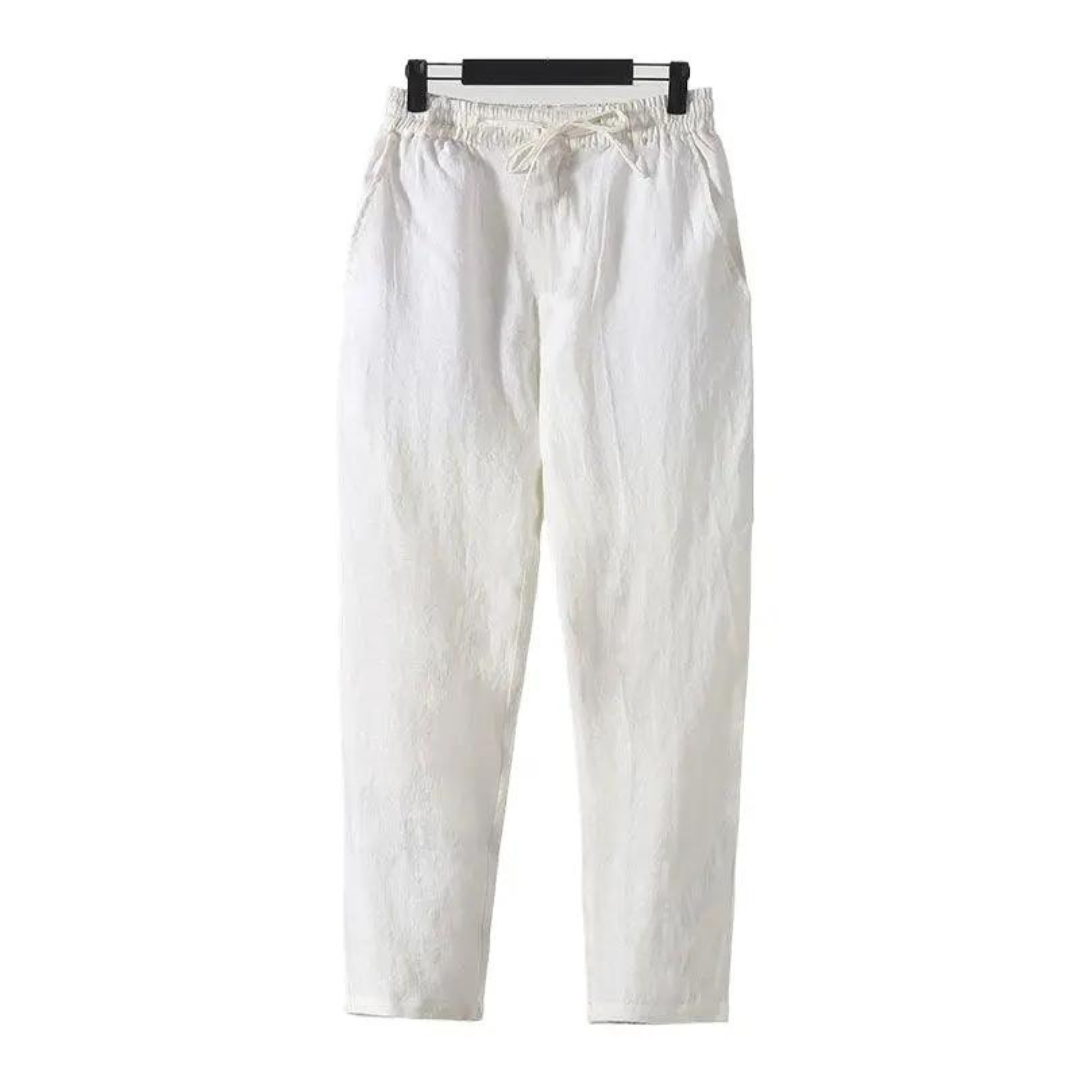 Sahara Whisper white linen pants, straight fit, soft touch finish, hanging front view with drawstring waist. Lightweight and breathable.