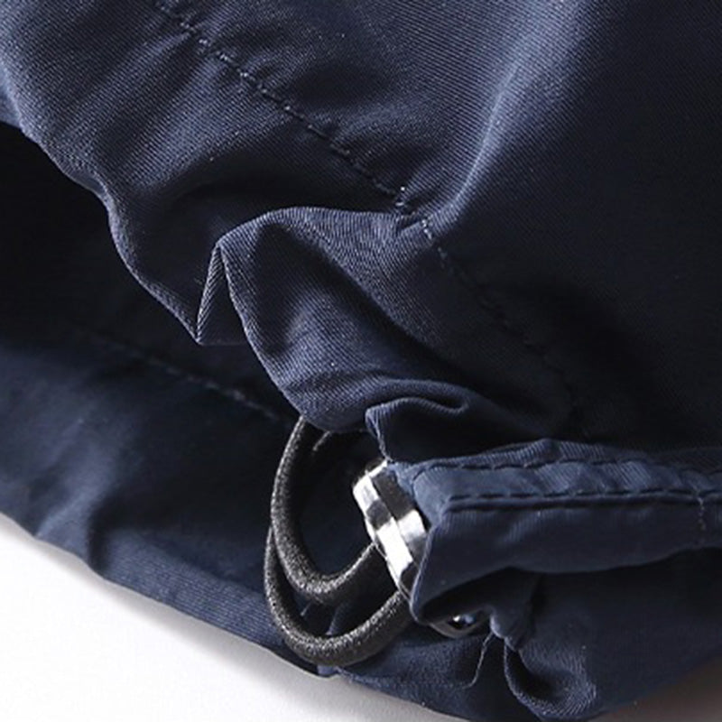 Close-up view of the navy Sakura Breeze waterproof breathable casual pants, highlighting the elastic drawstring cuff and toggle for an adjustable relaxed fit.