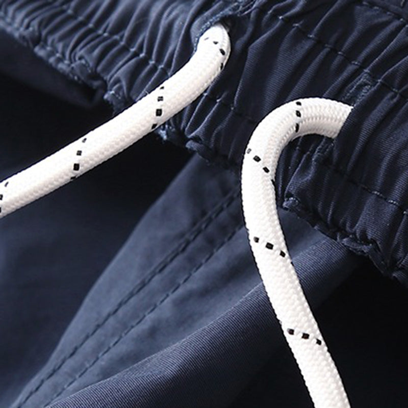 Close-up view of the navy Sakura Breeze waterproof breathable casual pants waistband, featuring white drawstrings with black speckles for an adjustable fit.