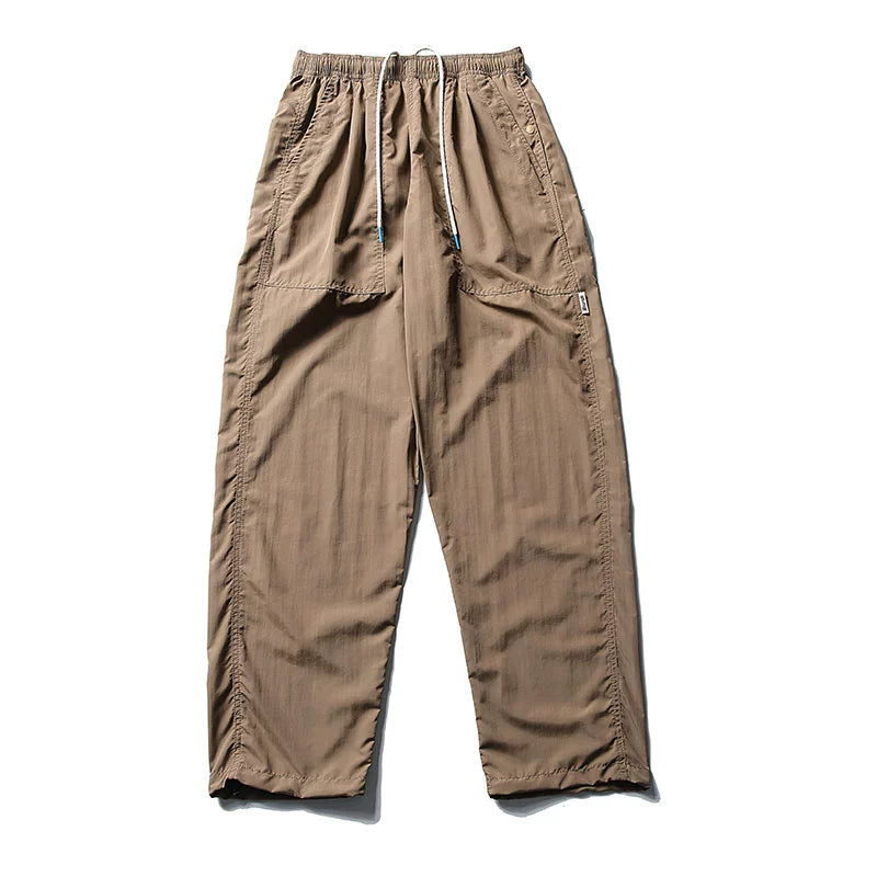 Front view of Sakura Breeze men's waterproof breathable casual pants in khaki, featuring a relaxed fit, straight leg, and a visible drawstring waist.