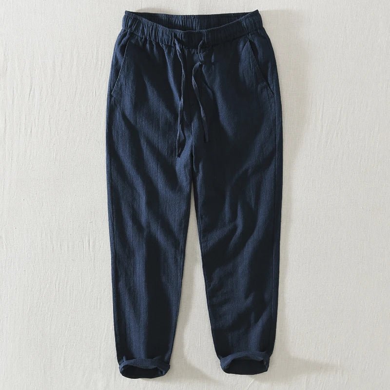 Men's Samurai Elegance Japan style relaxed fit linen pants in blue, featuring a drawstring waist and cuffed ankles, laid flat on a light background.