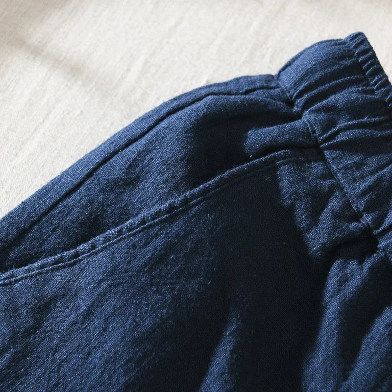 Close-up view of the blue Samurai Elegance men's linen pants, highlighting the elastic drawstring waist, side pocket detail, and linen fabric texture.