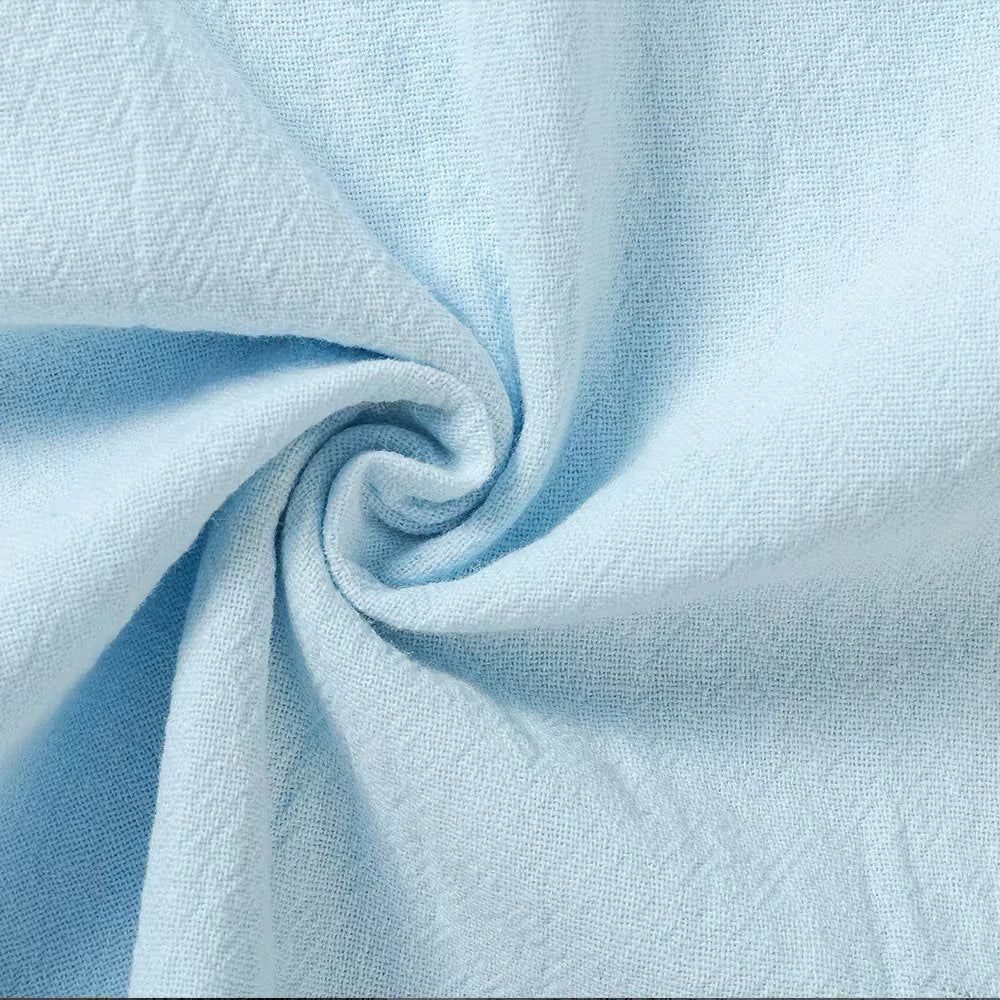 Close-up view of the light blue linen fabric for the Seaside Retreat relaxed fit pants, showcasing its breathable texture and quality weave. Emphasizes the lightweight and comfortable material.