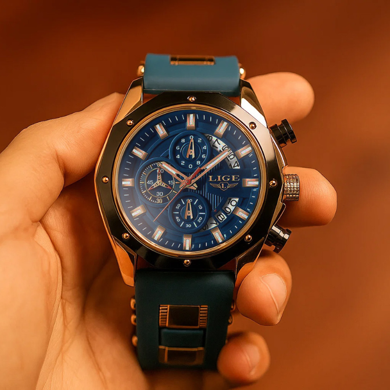 Close-up of the Skyline Aviator men's watch with a blue dial, gold case, and blue silicone strap, held in a hand. The watch features an analog display, chronograph sub-dials, and luminous hands.