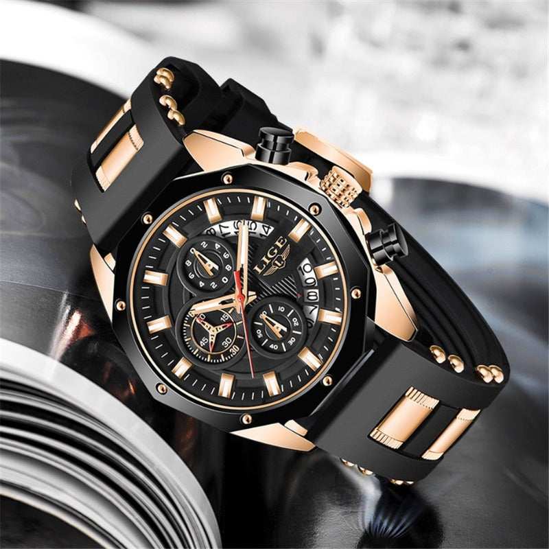 Close-up of the Skyline Aviator men's quartz watch, featuring a gold case, black dial with luminous hands, chronograph subdials, and a black silicone strap with gold accents, resting on a white surface.