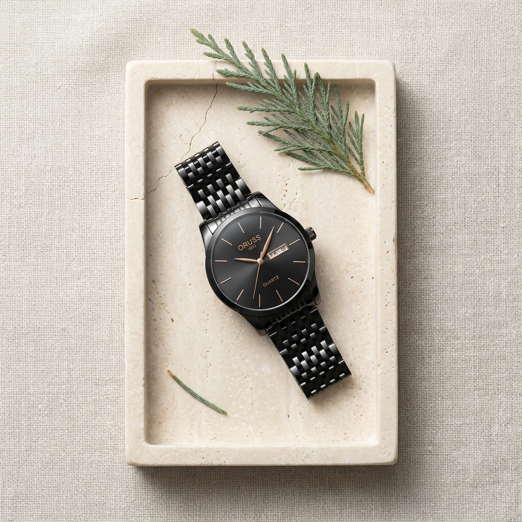 Black dial stainless steel bracelet men's wrist watch lifestyle scene beside pillow on charcoal ceramic bedside table
